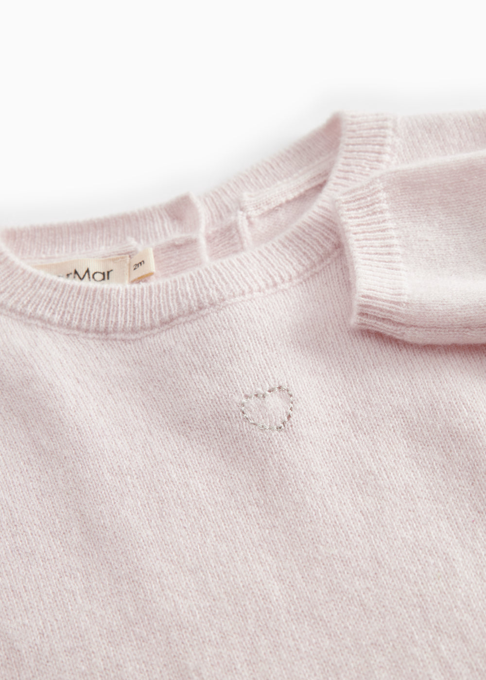 Lyserød melange cashmere heldragt med ribkant og knaplukning ved hals