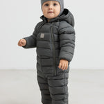 Baby iført mørkegrøn dundragt med hue