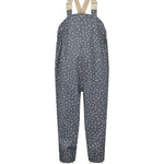 Børne-regnbukser i mørkeblå med små hvide blomster, justerbare seler og fodstropper