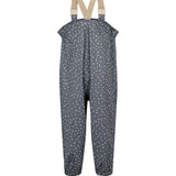 Børne-regnbukser i mørkeblå med små hvide blomster, justerbare seler og fodstropper