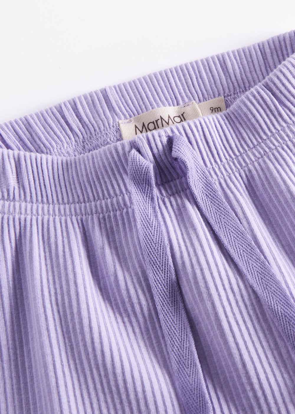 Lilla ribstrikkede babybukser med elastisk talje og snor