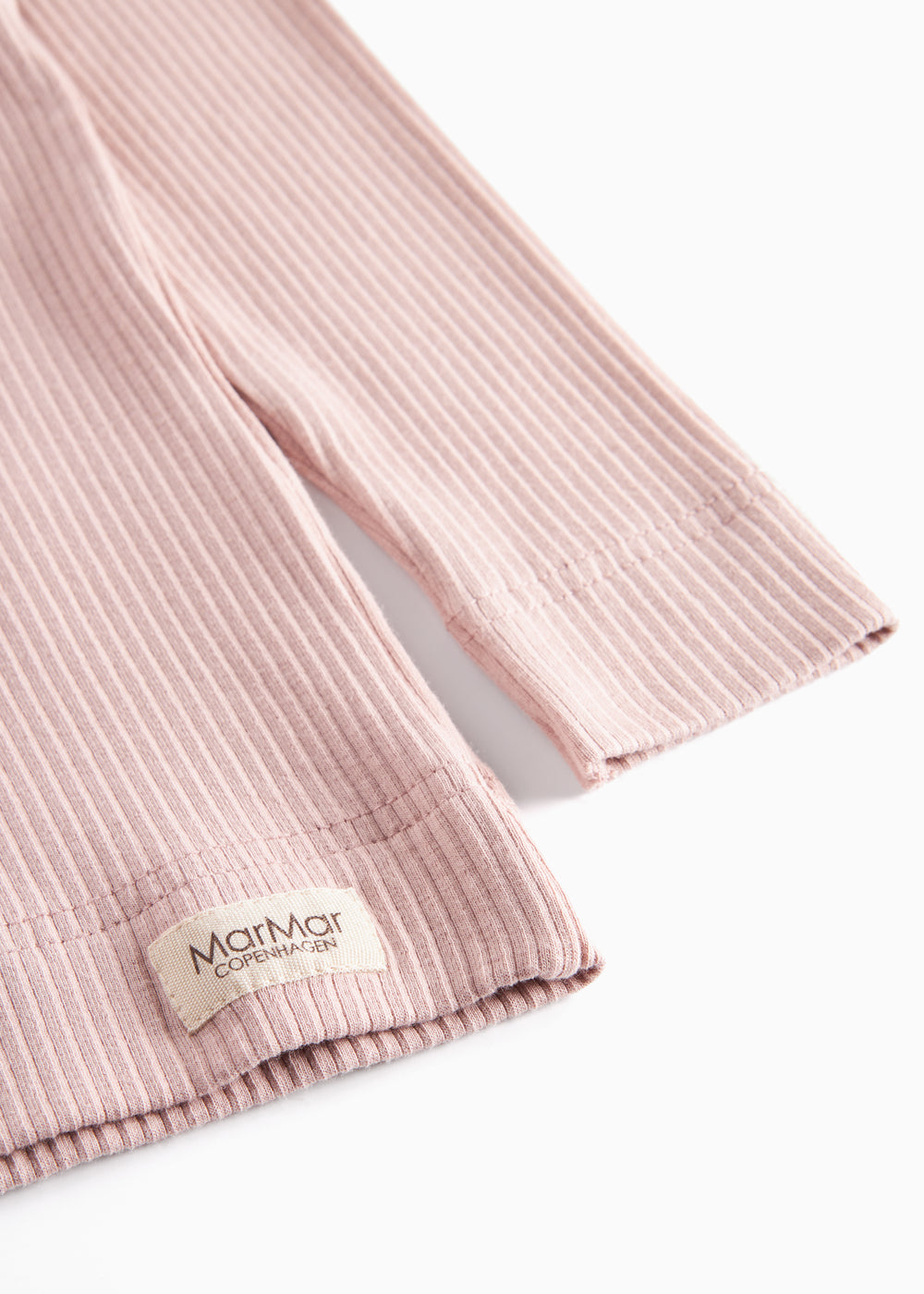 Detalje af ribstrikket nederste kant på rosa børnetøj