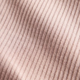 Detalje af lys rosa ribstrikket stof på børnehue