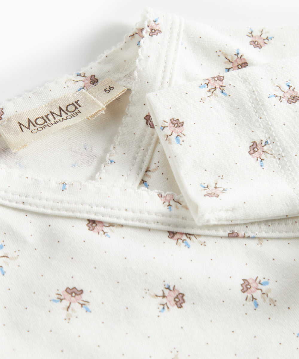 Langærmet bodystocking til nyfødte med slå-om-lukning og blomstermønster