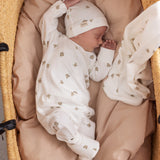 Sovende baby iført heldragt og hue