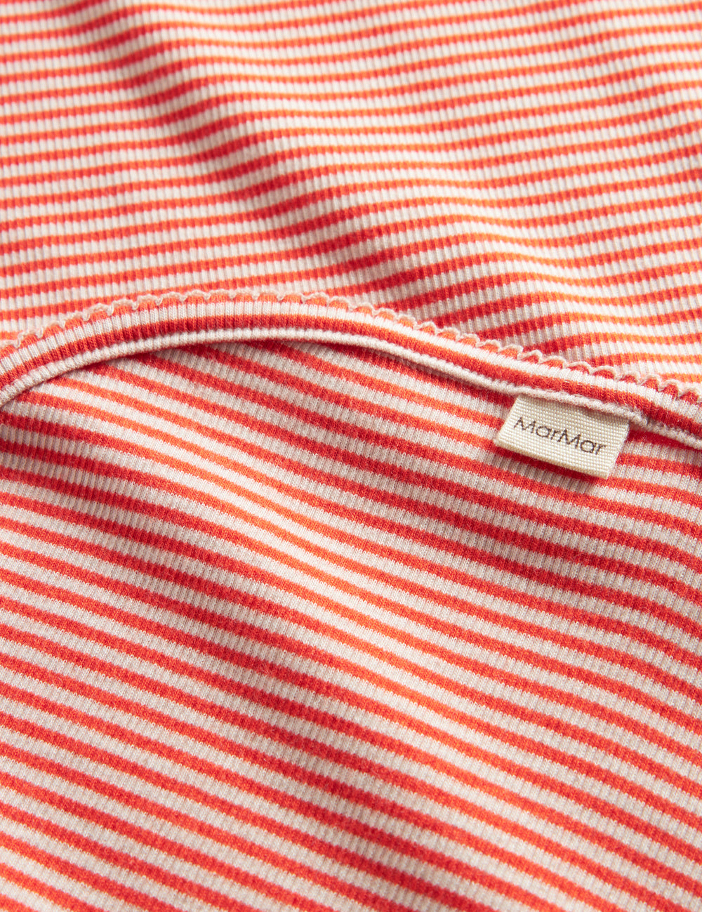 Rødt og hvit strikket babyteppe