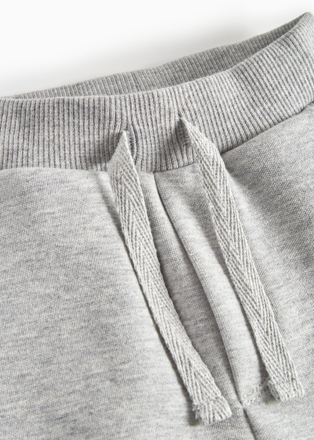 Detalje af snøre i talje på grå joggingbukser til børn