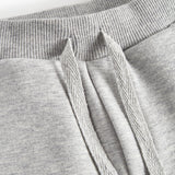 Detalje af snøre i talje på grå joggingbukser til børn