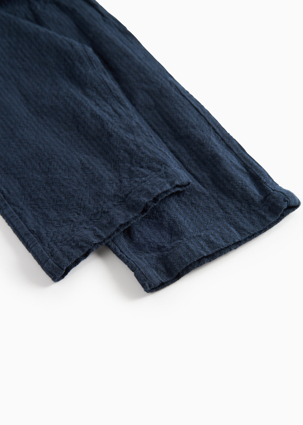 Detaljebillede af benkant på mørkeblå bukser