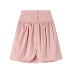 Lyserød nederdel i babyfløjl med knapper og bølgekant til børn