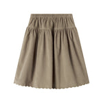 Beige nederdel i babyfløjl med knapper og bølgekant til børn