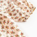 Nærbillede af kjoleærme med blomstermønster og elastik