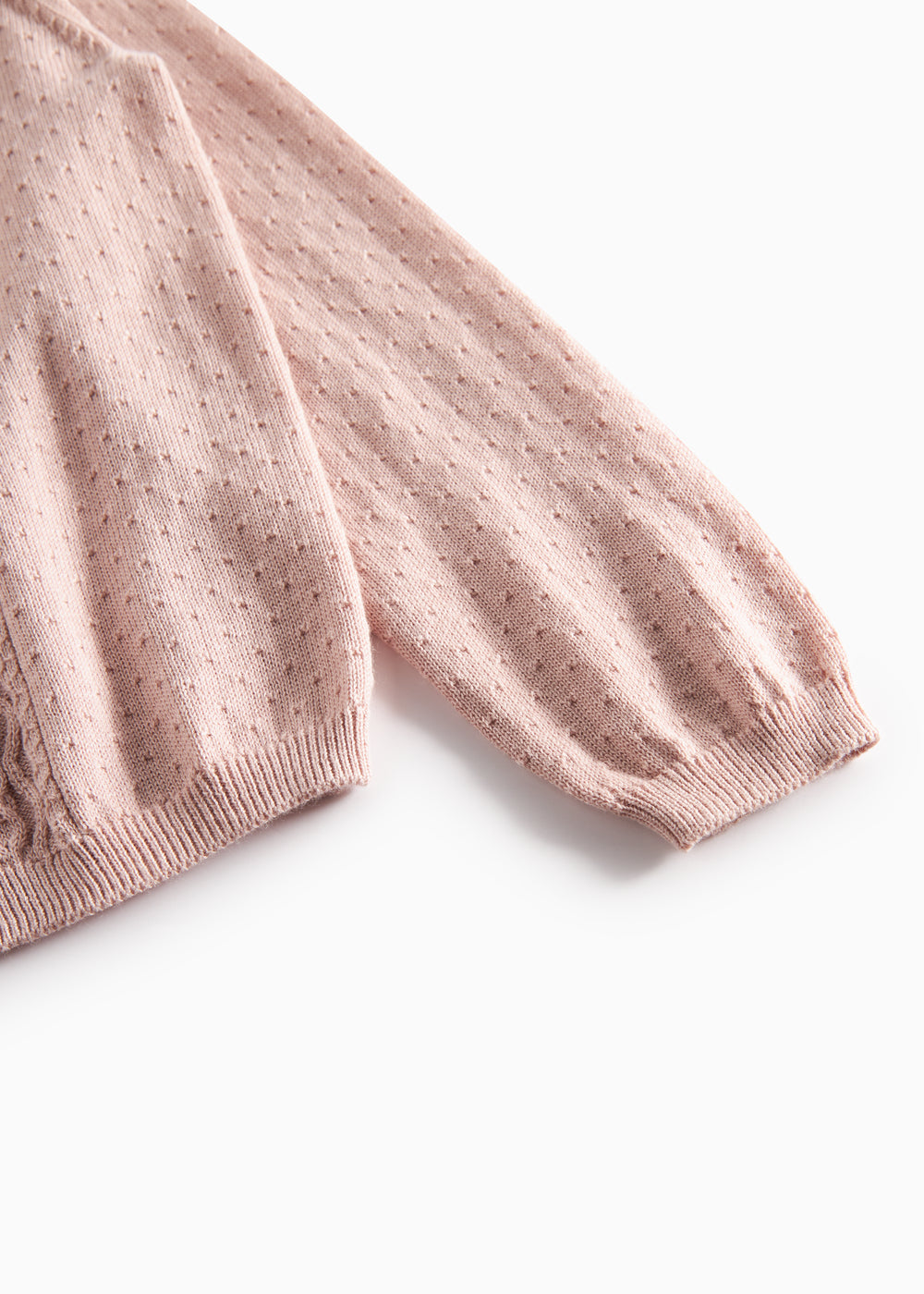 Nærbillede af ærme med ribkant på lyserød strikcardigan