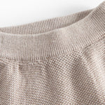 Nærbillede af beige strikket babybukser