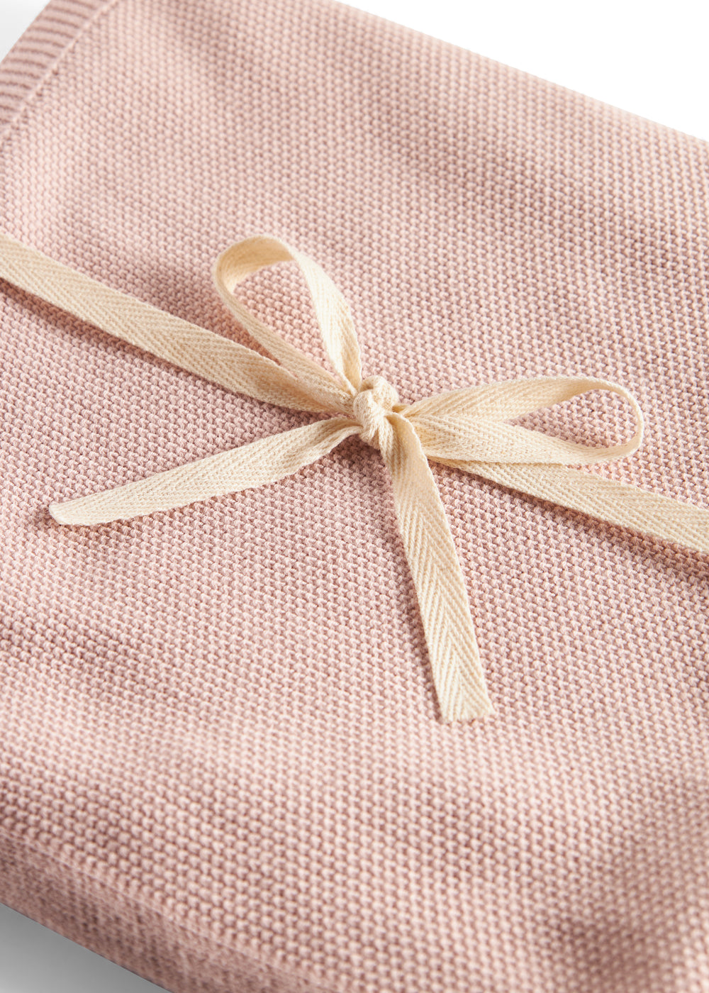 Lyserød strikket babytæppe