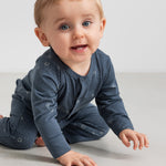 Baby iført mørkeblå heldragt med stjerneprint