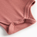 Støvet rosa ribstrikket babybody 