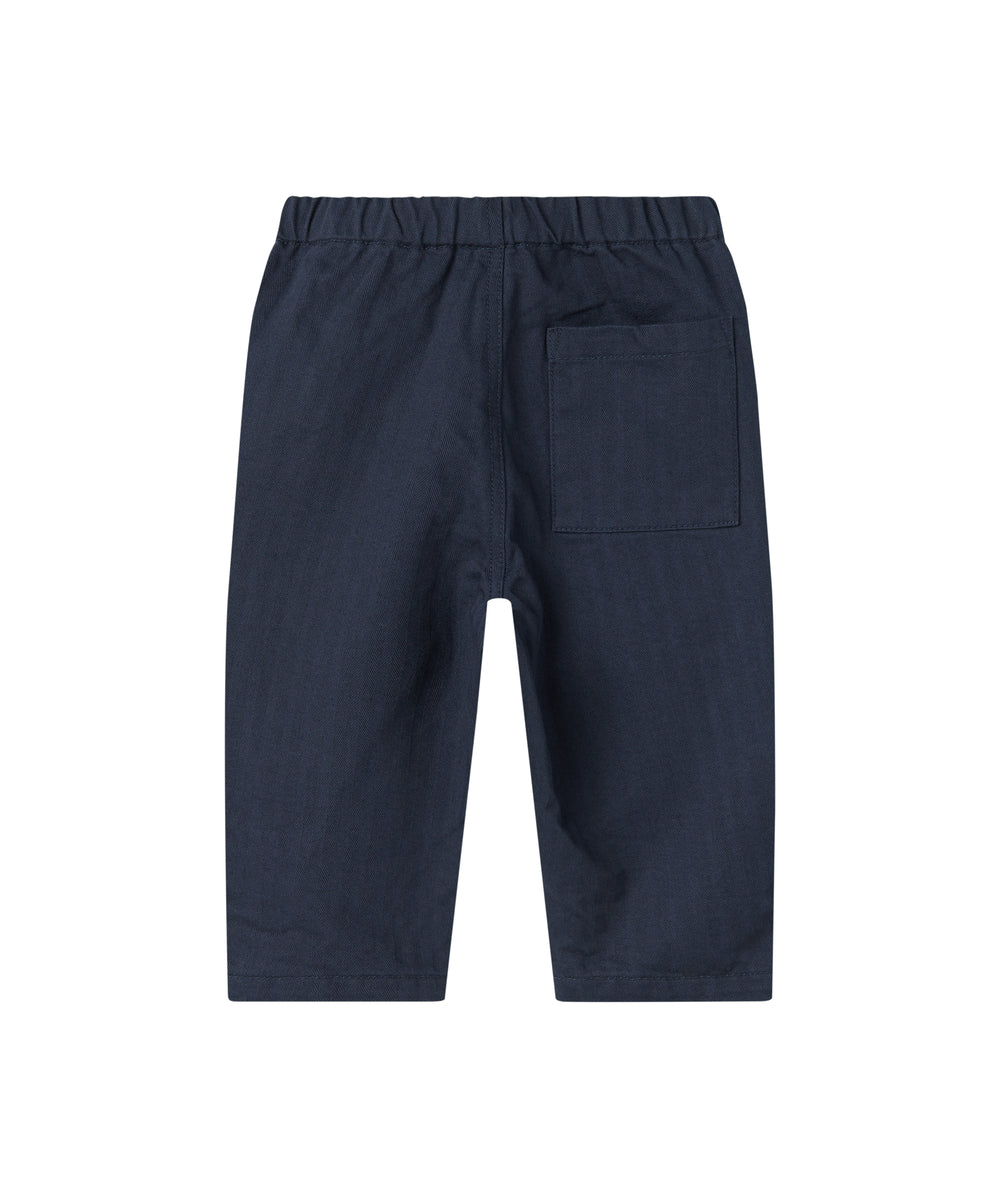 Mørkeblå bukser med elastisk talje og bindebånd i blødt stof til baby