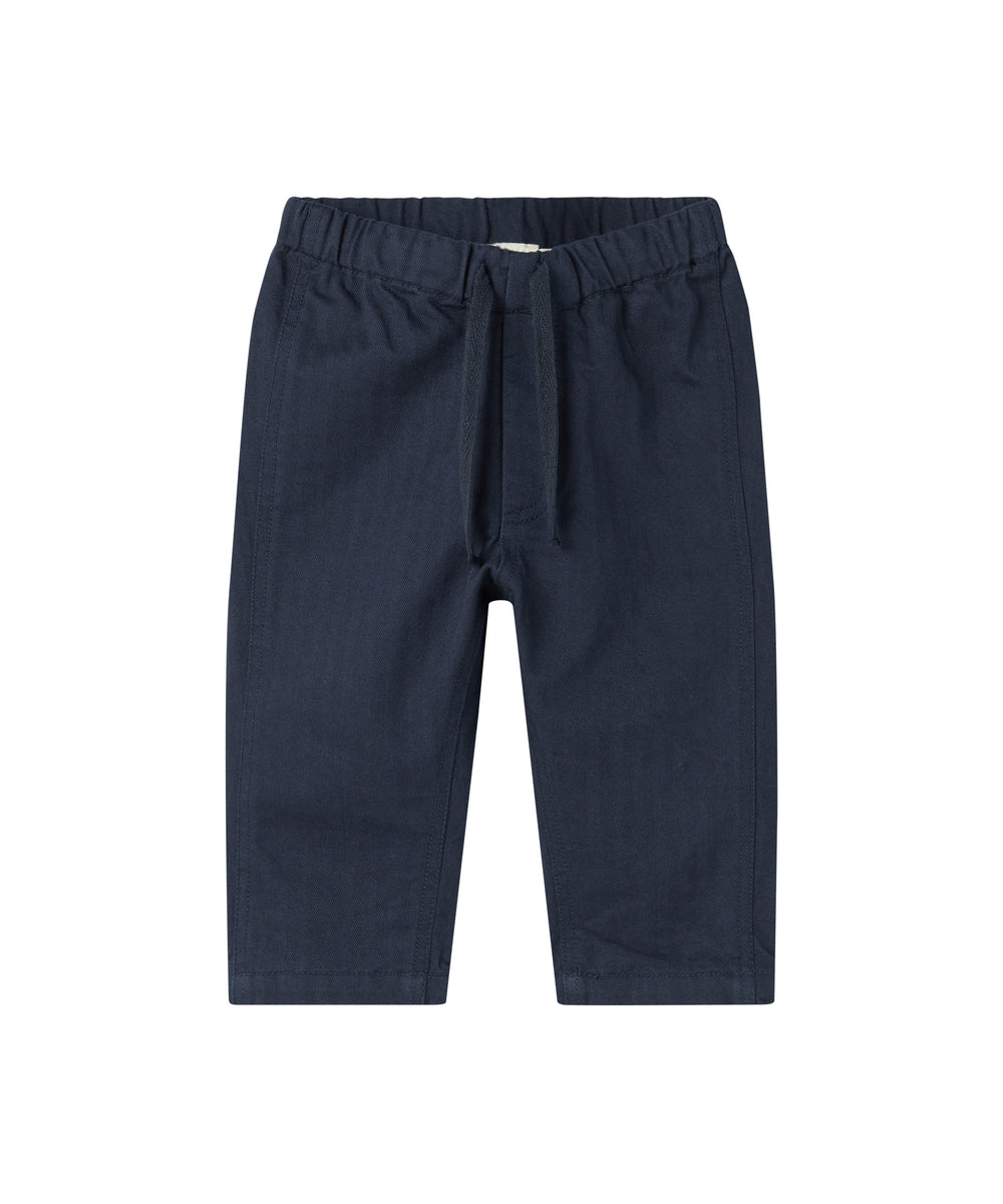 Mørkeblå bukser med elastisk talje og bindebånd i blødt stof til baby