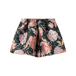 Kort mørkegrøn nederdel med store blomster og sløjfedetalje til børn