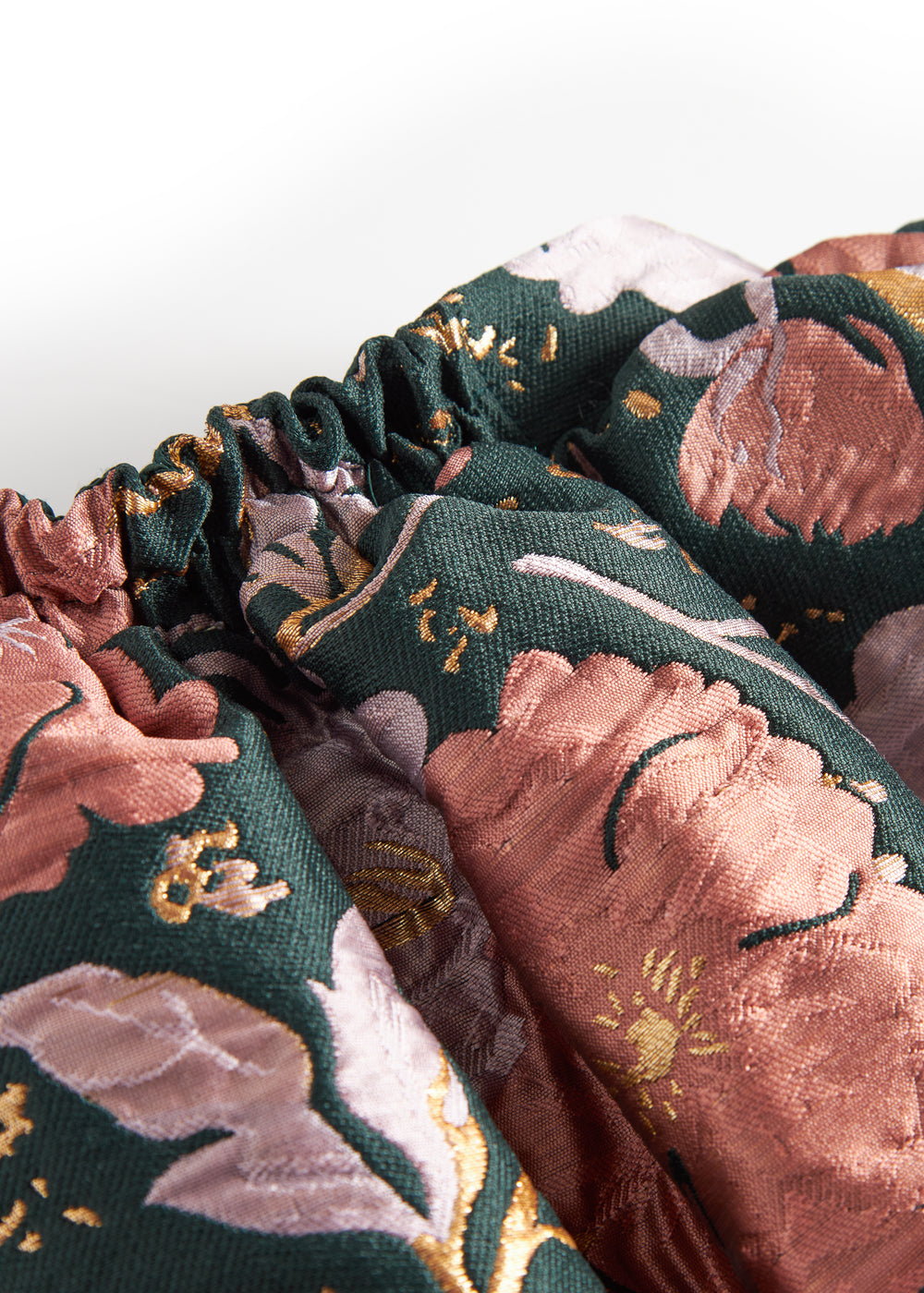 Kort mørkegrøn nederdel med store blomster og sløjfedetalje til børn