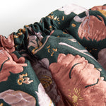 Kort mørkegrøn nederdel med store blomster og sløjfedetalje til børn