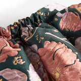 Kort mørkegrøn nederdel med store blomster og sløjfedetalje til børn