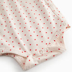 Langærmet bodystocking til nyfødte med slå-om-lukning og hjerte print