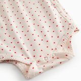 Langærmet bodystocking til nyfødte med slå-om-lukning og hjerte print