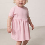 Barn iført lyserødstribet kjole med løs pasform