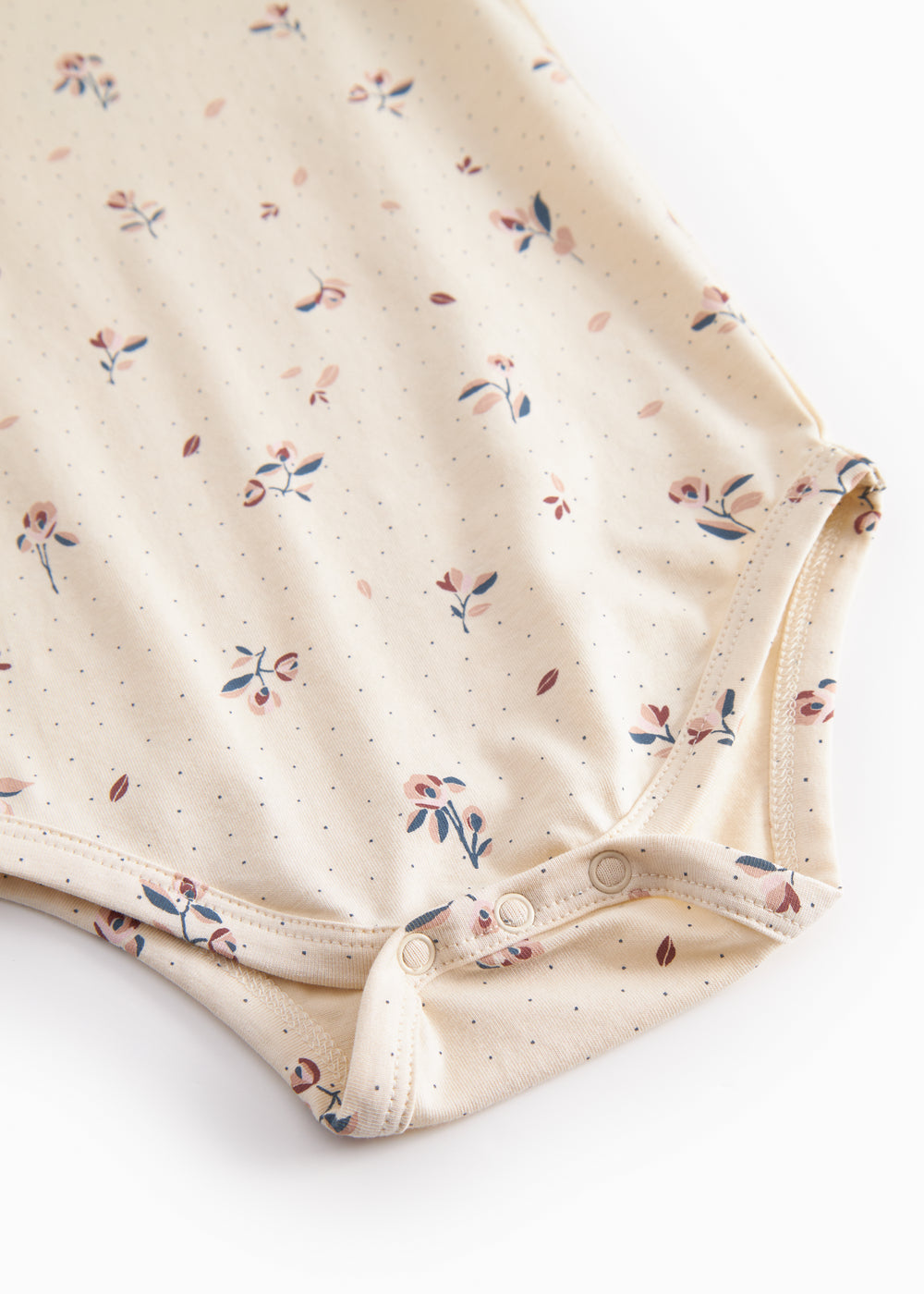 Langærmet baby bodystocking med blomstrprint og knaplukning