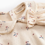 Langærmet baby bodystocking med blomstrprint og krave