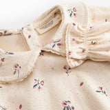 Langærmet baby bodystocking med blomstrprint og krave