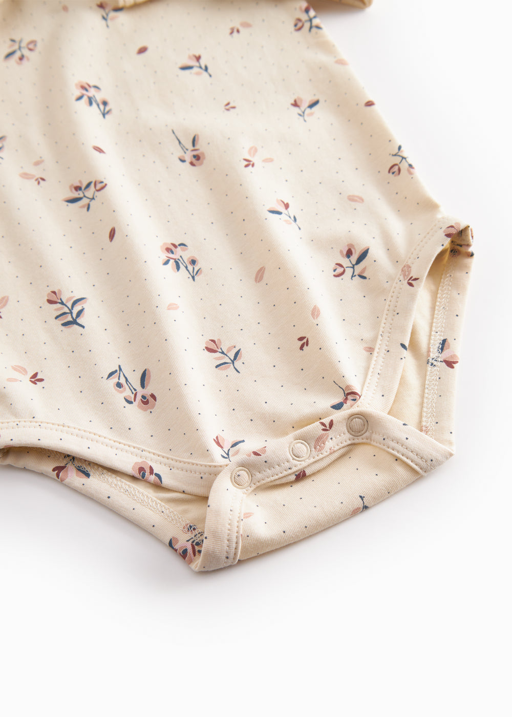 Langærmet baby bodystocking med blomstrprint og krave