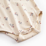 Langærmet baby bodystocking med blomstrprint og krave