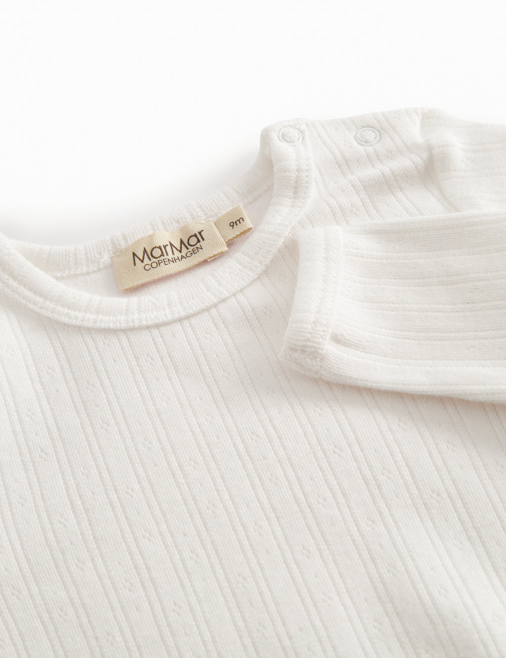 Langærmet hvid pointelle baby bodystocking