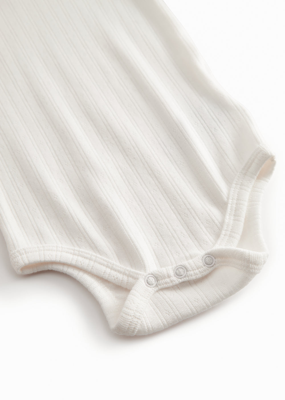 Langærmet hvid pointelle baby bodystocking