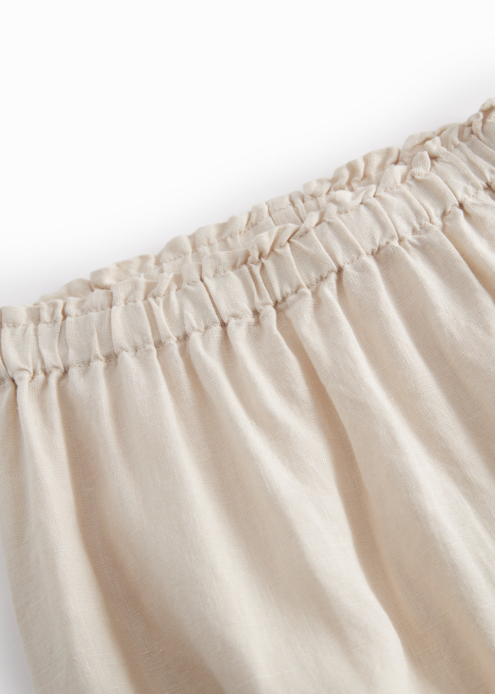 Beige bukser til baby med løs pasform  og elastik i taljen 