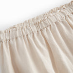 Beige bukser til baby med løs pasform  og elastik i taljen 