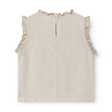 Ærmeløs beige top til børn med  flæsedetaljer