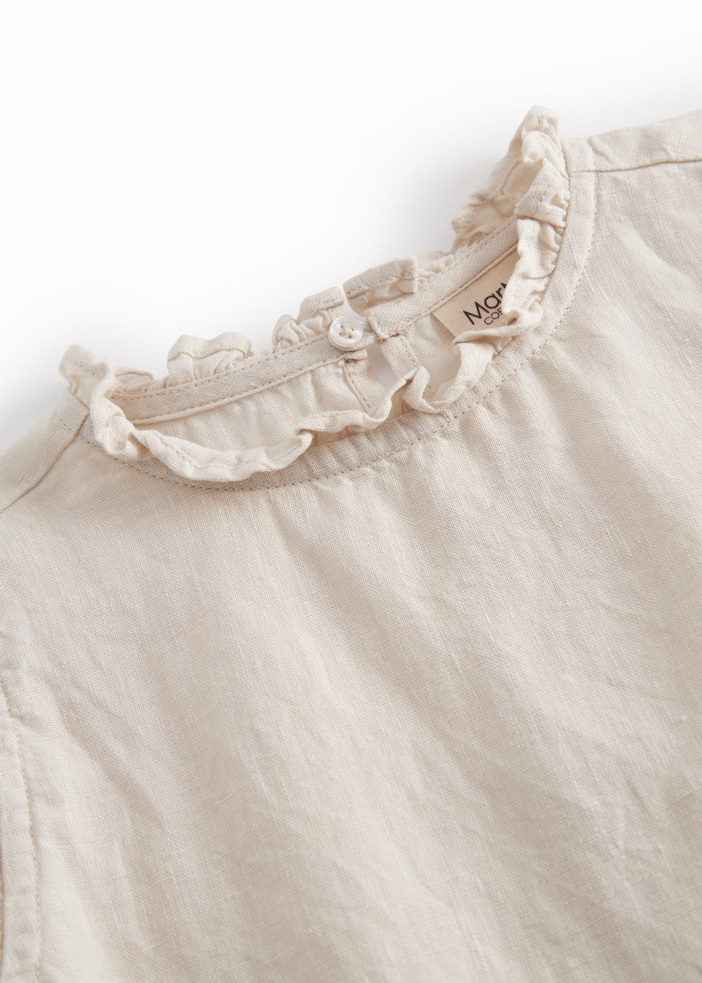 Ærmeløs beige top til børn med  flæsedetaljer