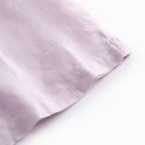 Ærmeløs lys lilla top til børn med flæsedetaljer