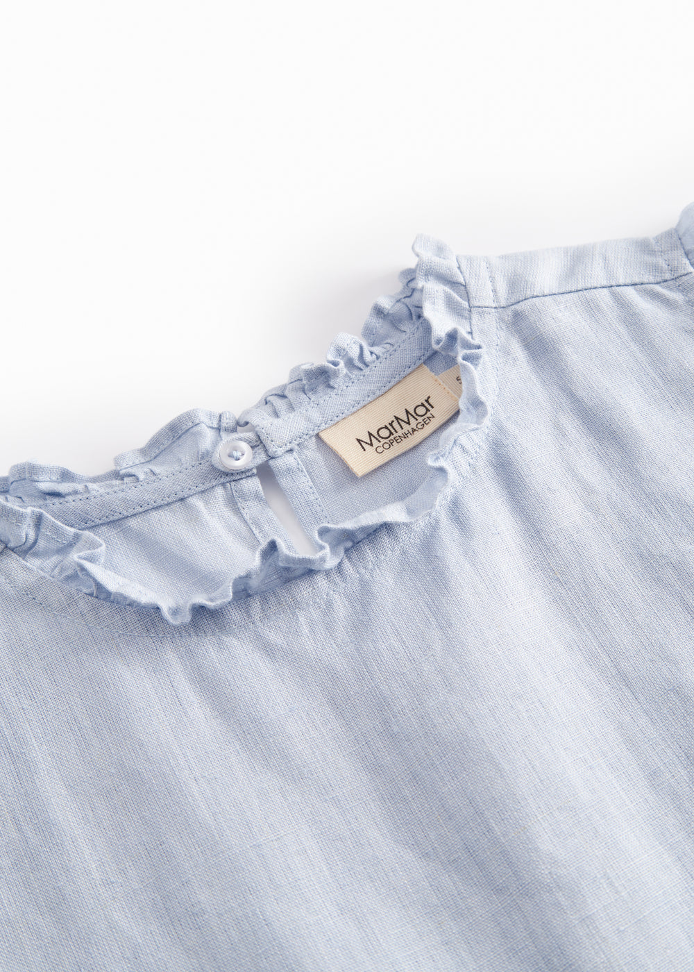 Ærmeløs lyseblå top til børn med flæsedetaljer