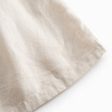 Beige nederdel til børn med sidelommer og knapper