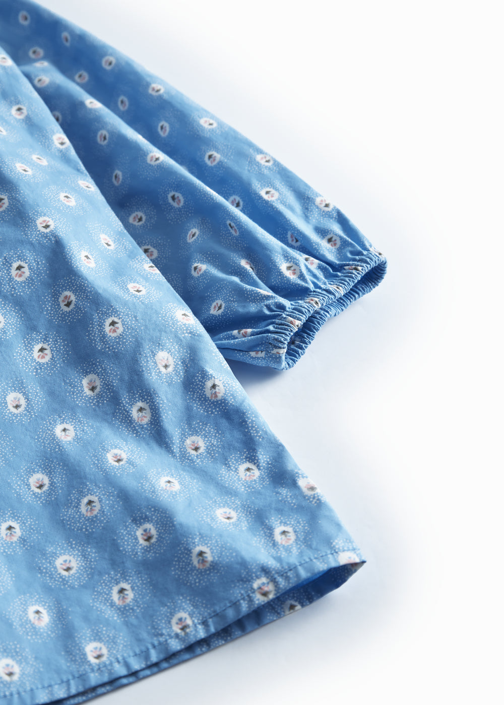 Blå børnekjole med lange ærmer, flæser  og små blomster