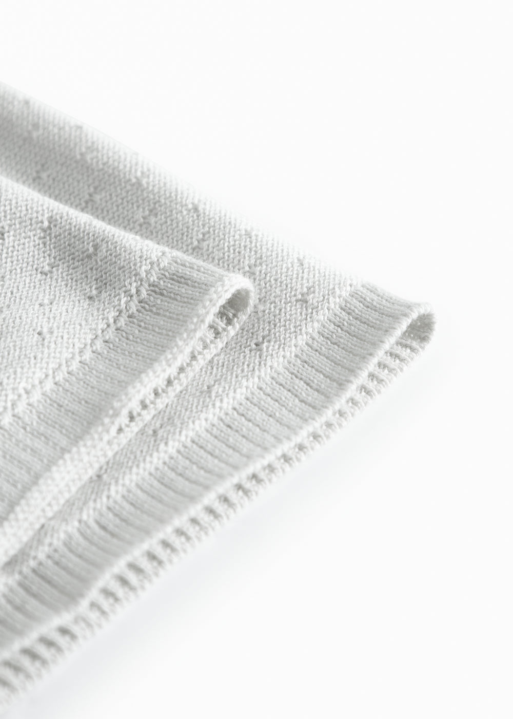 Lysegrøn baby striktæppe med hulmønster