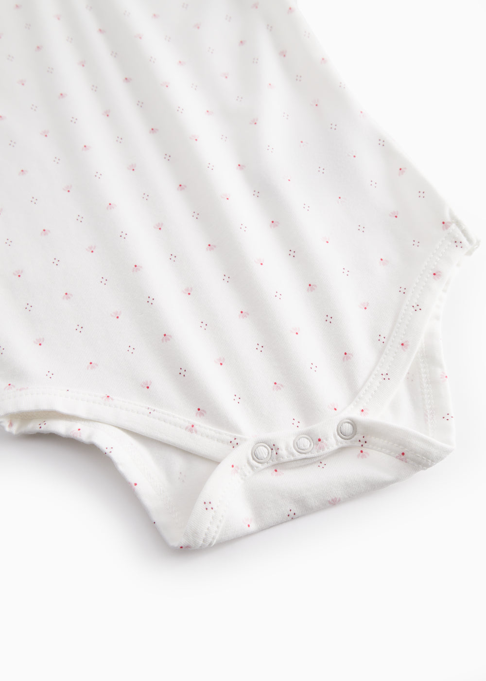 Hvid kortærmet baby bodystocking med små blomster