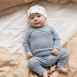 Lyseblå heldragt på baby med lange ærmer og ben i ribbet struktur