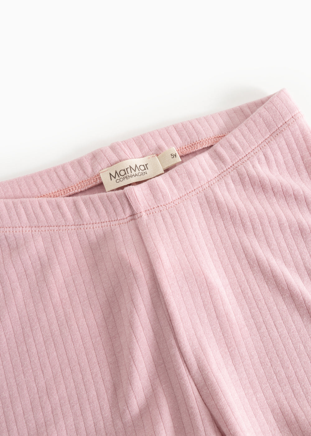 Lyserøde leggings med elastisk linning og synligt mærke på indersiden.