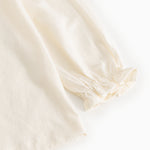 Offwhite bluse med pufærme og elastisk manchet